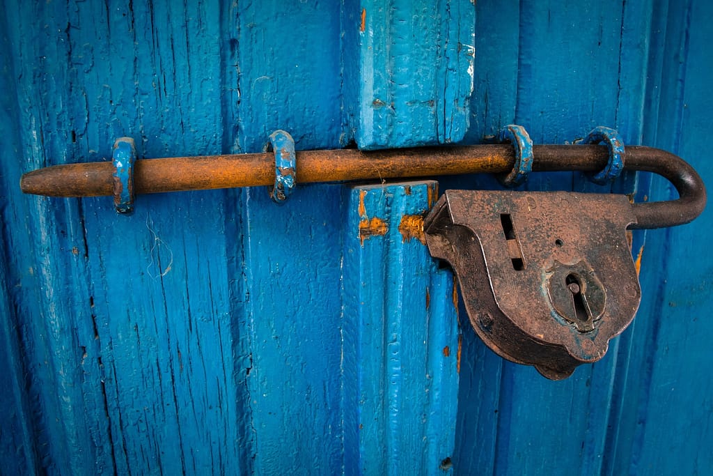 Large lock securing a big blue door.