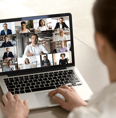 Laptop user connected to users via video conference